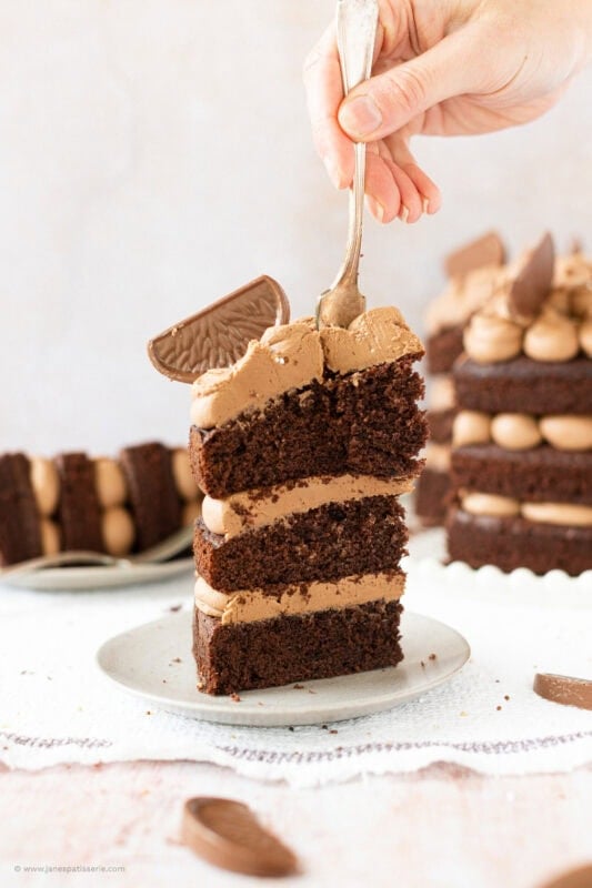 A fork cutting into a slice of Terrys chocolate orange cake