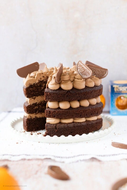 A slice of Terry's Chocolate Orange Cake missing from a whole cake